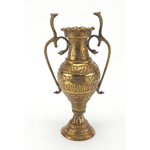 590 - Middle Eastern brass vase, with serpent twin handles, the body embossed with animals amongst trees, ... 