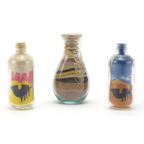 552 - Three sand art glass bottles, the largest 10.5cm high