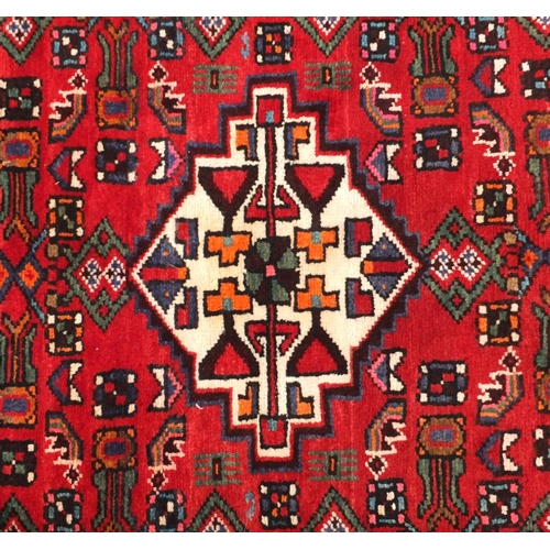 92 - Rectangular Hamadan rug with an all over floral and animal decoration, 220cm x 133cm