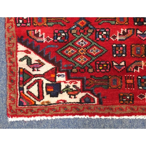 92 - Rectangular Hamadan rug with an all over floral and animal decoration, 220cm x 133cm