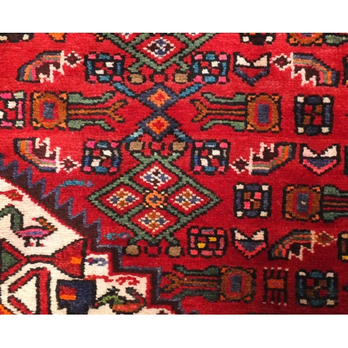 92 - Rectangular Hamadan rug with an all over floral and animal decoration, 220cm x 133cm