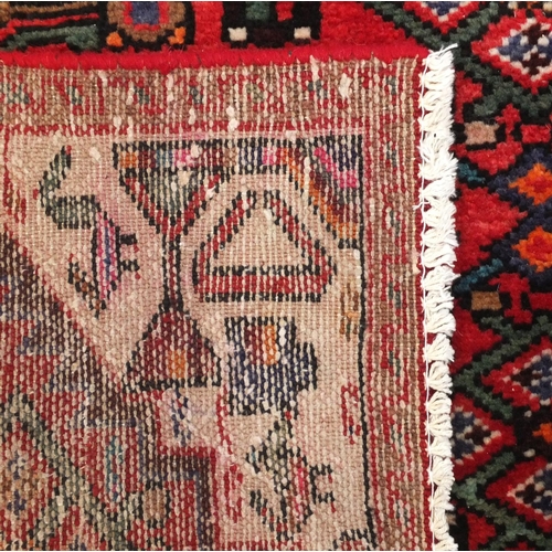 92 - Rectangular Hamadan rug with an all over floral and animal decoration, 220cm x 133cm