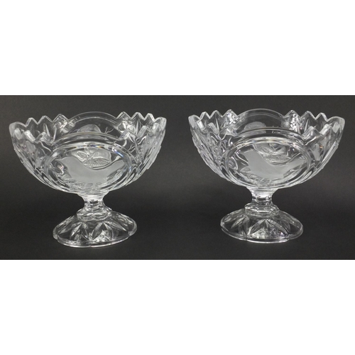 493 - Pair of clear glass pedestal bowls, decorated in relief with birds, 18cm high x 23cm in diameter