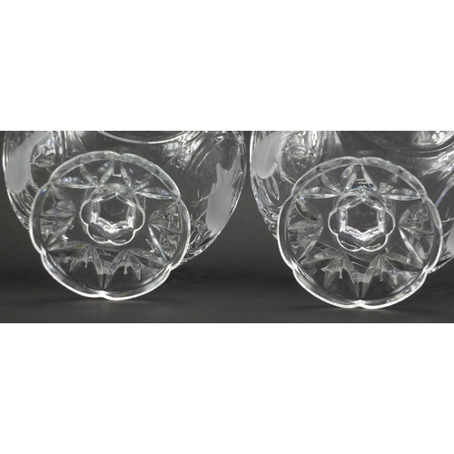 493 - Pair of clear glass pedestal bowls, decorated in relief with birds, 18cm high x 23cm in diameter