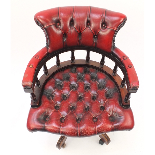 47 - Mahogany framed captains chair with oxblood leather buttonback upholstery