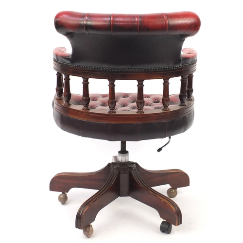 47 - Mahogany framed captains chair with oxblood leather buttonback upholstery