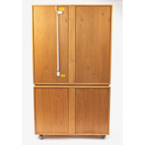 2010 - Ercol light elm wall unit fitted with a pair of glazed doors above a pair of cupboard doors and draw... 