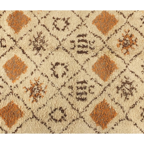 54 - Rectangular Moroccan Berber rug, having a geometric design onto a predominantly cream ground, 296cm ... 