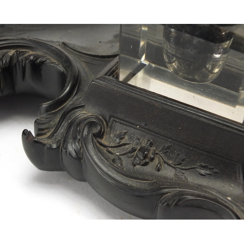 187 - 19th century ebonised desk stand, with two glass inkwells and a dog design pen wipe, 30.5cm wide