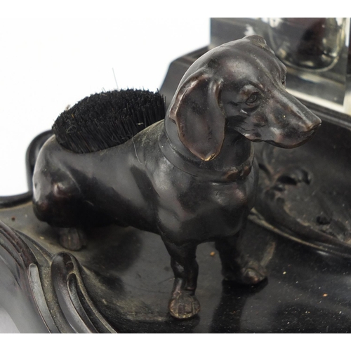 187 - 19th century ebonised desk stand, with two glass inkwells and a dog design pen wipe, 30.5cm wide