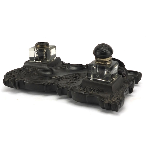 187 - 19th century ebonised desk stand, with two glass inkwells and a dog design pen wipe, 30.5cm wide