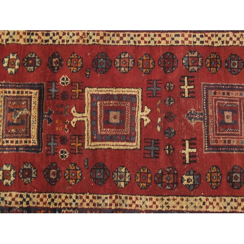 79 - Rectangular Persian rug having and all over flower head and geometric design, 187cm x 96cm