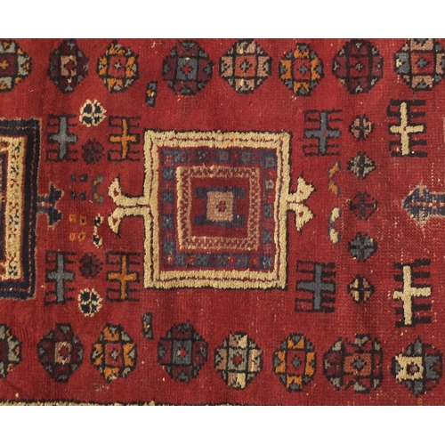 79 - Rectangular Persian rug having and all over flower head and geometric design, 187cm x 96cm