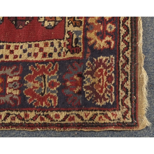 79 - Rectangular Persian rug having and all over flower head and geometric design, 187cm x 96cm