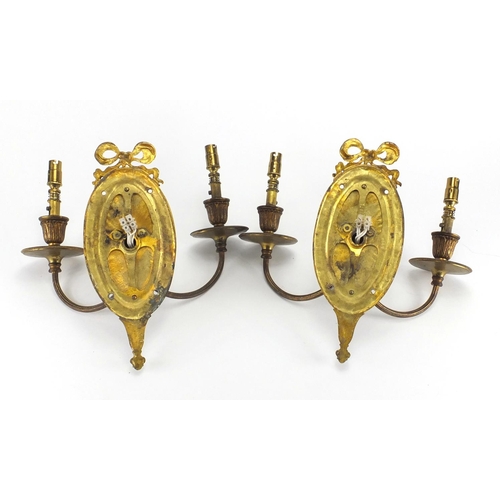 674 - Pair of Ormolu rams head design twin wall sconces, each 27cm high