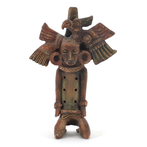 762 - Peruvian hand painted terracotta flute in the form of a kneeling man, 24.5cm in length