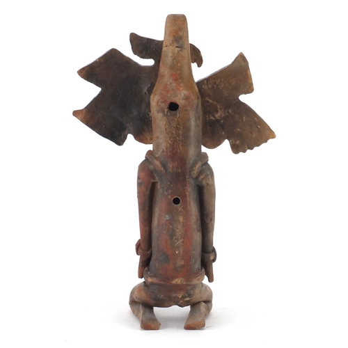 762 - Peruvian hand painted terracotta flute in the form of a kneeling man, 24.5cm in length