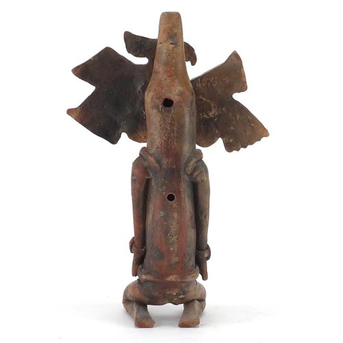 762 - Peruvian hand painted terracotta flute in the form of a kneeling man, 24.5cm in length