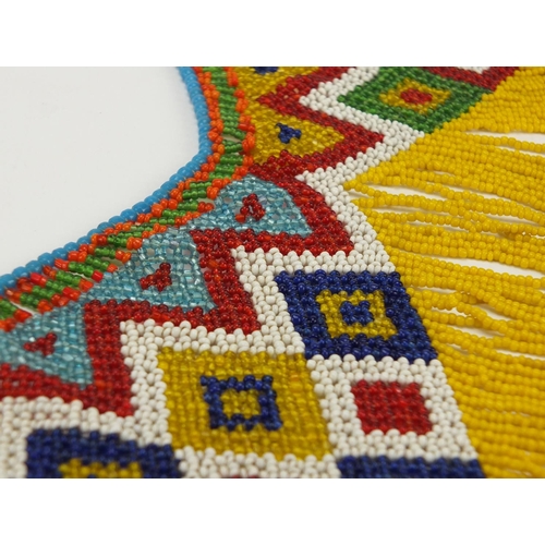 763 - African tribal beadwork apron having a geometric design, 70cm in length