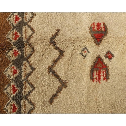 94 - Rectangular Moroccan Berber rug, having a geometric design onto a predominantly cream ground, 296cm ... 