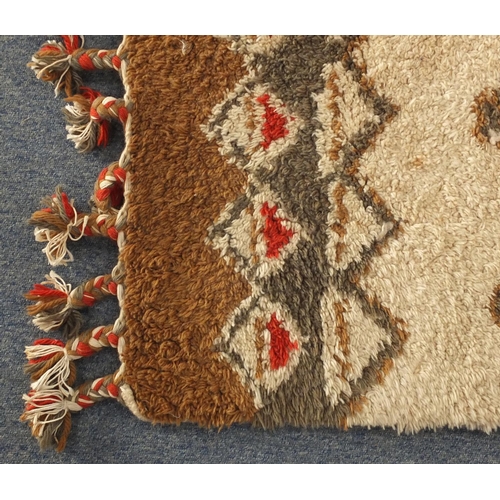 94 - Rectangular Moroccan Berber rug, having a geometric design onto a predominantly cream ground, 296cm ... 