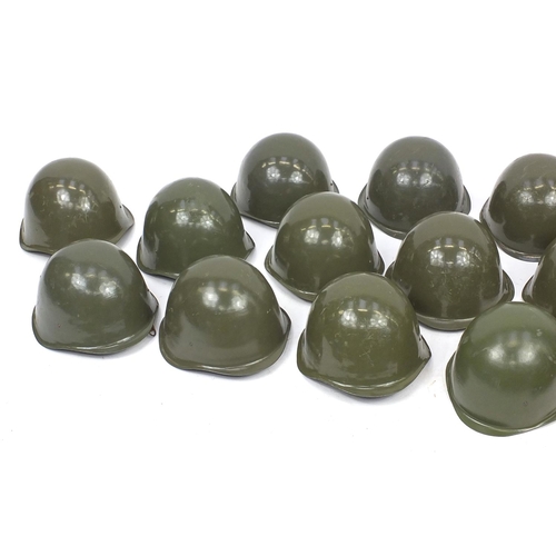 916 - Twelve Cold War unissued helmets with bag