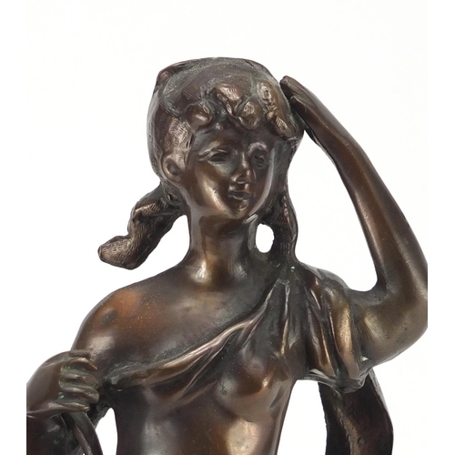 138 - Bronze figure of a young girl carrying a basket of fruit, 43cm high