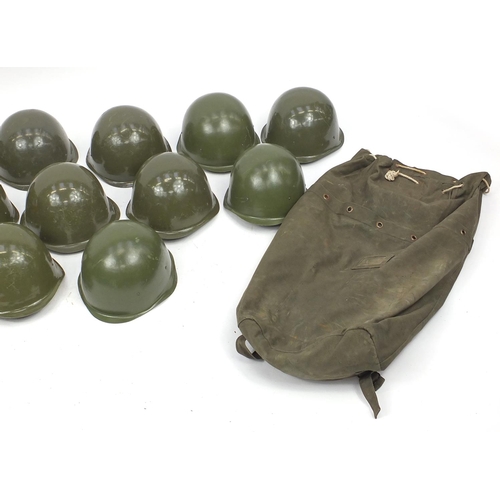 916 - Twelve Cold War unissued helmets with bag