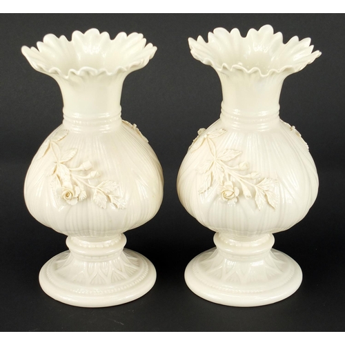 149 - Pair of Belleek porcelain vases, relief decorated with flowers, 20cm high