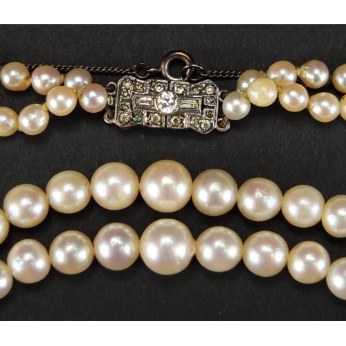 355 - Two string cultured pearl necklace, with unmarked silver clasp, housed in a S. L. Simmons tooled lea... 