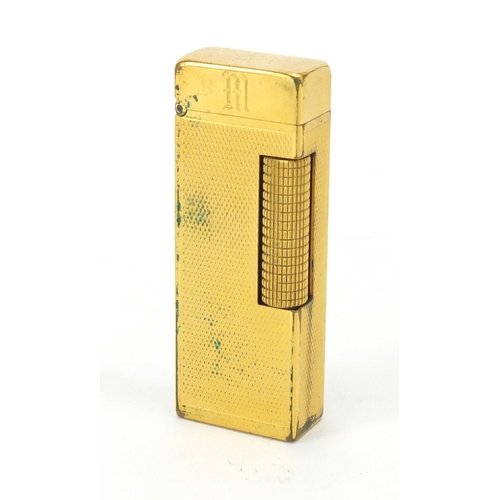 394 - Dunhill gold plated pocket lighter, with engine turned decoration and leather case