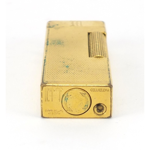 394 - Dunhill gold plated pocket lighter, with engine turned decoration and leather case