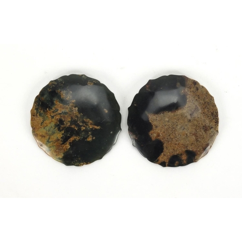 424 - Two Chinese circular jade discs with shaped edges, both carved with mythical creatures, 5.2cm in dia... 