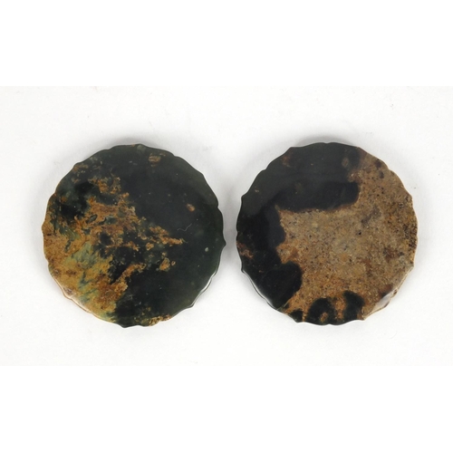 424 - Two Chinese circular jade discs with shaped edges, both carved with mythical creatures, 5.2cm in dia... 