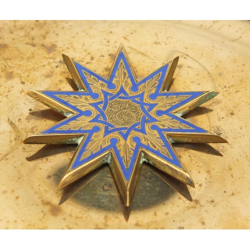 471 - Gilt copper and blue enamel wall hanging, with central star motif, probably Ottoman, 26cm in diamete... 