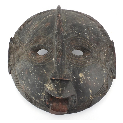 486 - African Tribal carved wooden face mask, 46cm in diameter