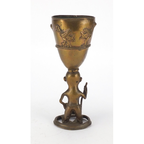 499 - Middle Eastern brass goblet with figural stem, 24cm high