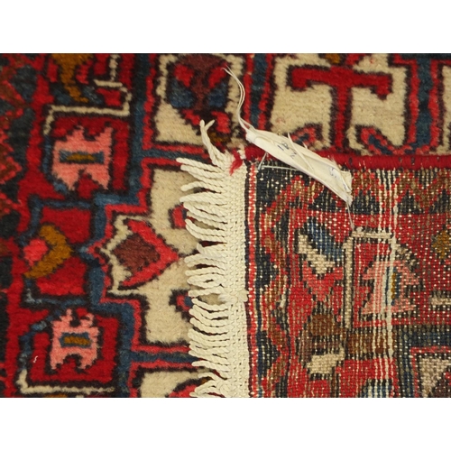 2034 - Rectangular Karabagh carpet runner, having a stylised repeat medallion design with flowers onto a re... 
