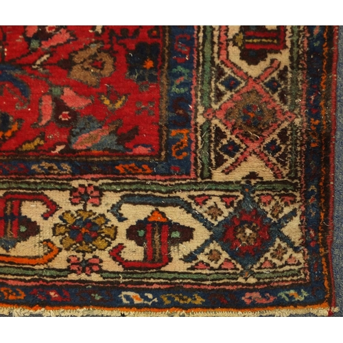 2028 - Rectangular Persian rug, having a stylised floral design, with corresponding borders, 220cm x 125cm