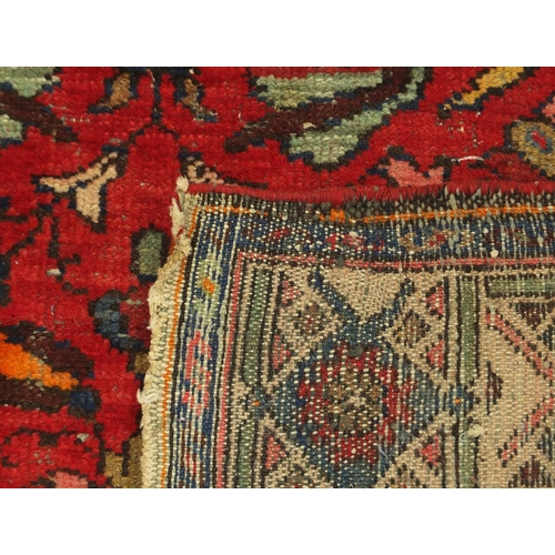 2028 - Rectangular Persian rug, having a stylised floral design, with corresponding borders, 220cm x 125cm