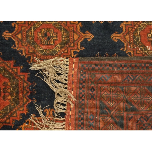 2035 - Rectangular Afghan rug, with stylised repeat medallion design, onto a blue ground, 155cm x 106cm