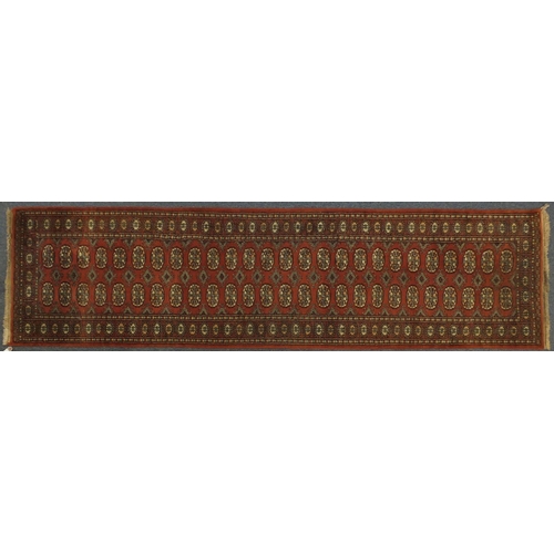 2044 - Rectangular Pakistan Bukhara carpet runner, 307cm x 79cm