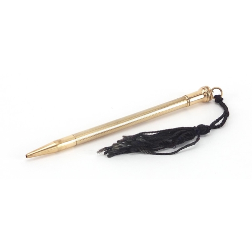 10 - 9ct gold propelling pencil, with engine turned body, 11cm in length, approximate weight 14.3g