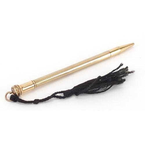 10 - 9ct gold propelling pencil, with engine turned body, 11cm in length, approximate weight 14.3g