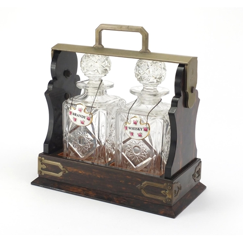 45 - Victorian coromandel and satin wood Tantalus, fitted with a pair of glass decanters and ceramic deca... 
