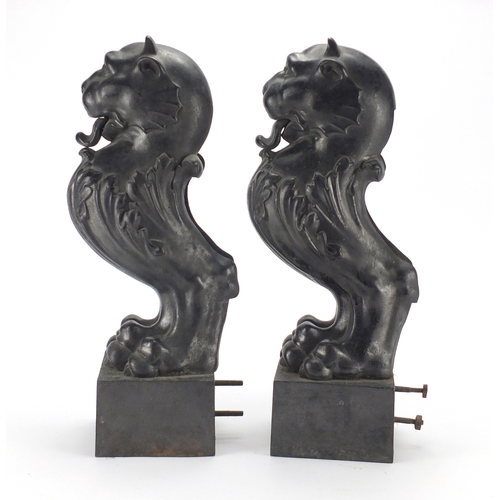 38 - Pair of antique cast iron seated lion doorstops, each 41.5cm high