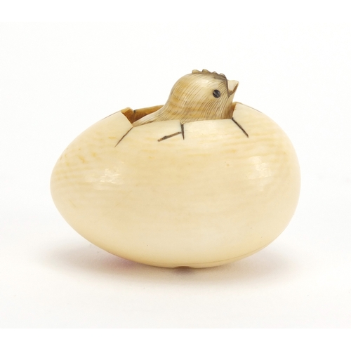35 - Cold painted bronze study of a bird, housing a Japanese carved ivory netsuke of a chick, character m... 