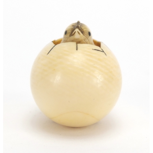 35 - Cold painted bronze study of a bird, housing a Japanese carved ivory netsuke of a chick, character m... 