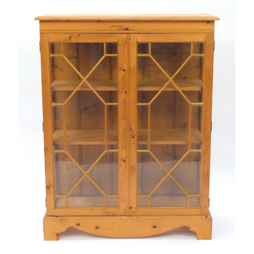 2030 - Pine display cabinet fitted with a pair of glazed doors two adjustable shelves, 124cm H x 94cm W x 3... 
