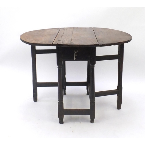 44 - Antique carved oak gateleg table, fitted with a frieze drawer to one end, 66cm H x 100cm W (extended... 